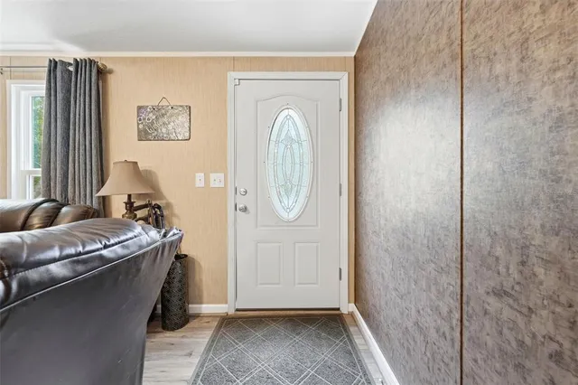a bathroom with a granite countertop sink a mirror and shower
