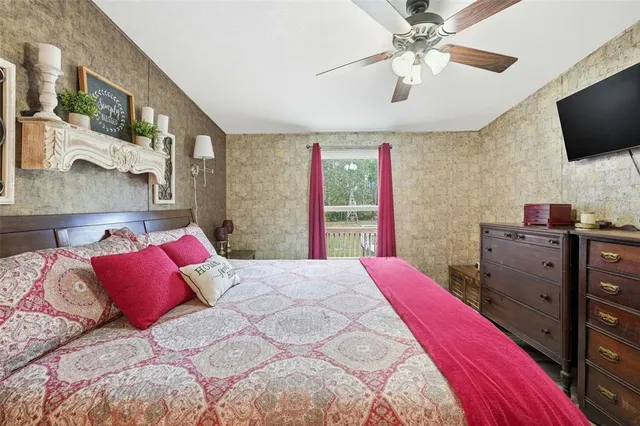 a bedroom with a bed and a chandelier