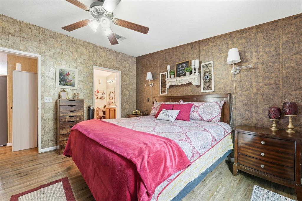 104 Ferncreek Drive Georgetown, FL 32139 - Photo 18 of 52 a bedroom with a bed and a chandelier