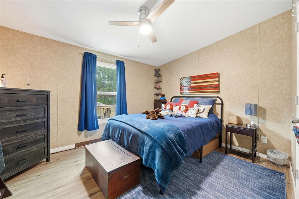 104 Ferncreek Drive Georgetown, FL 32139 - Photo 26 of 52 a bedroom with a bed and wooden floor