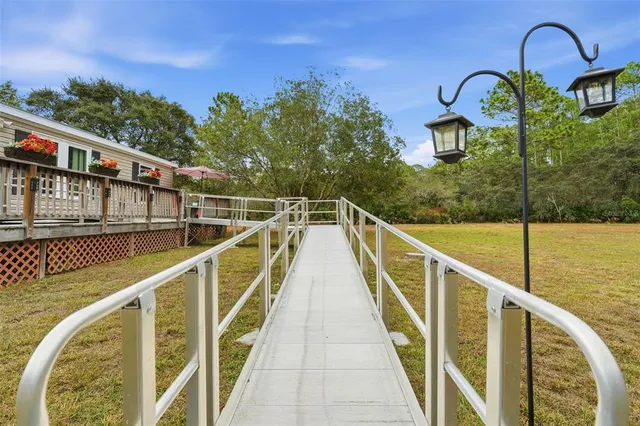 a swimming pool with outdoor seating and yard