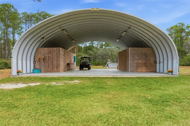 a view of a house with backyard and patio