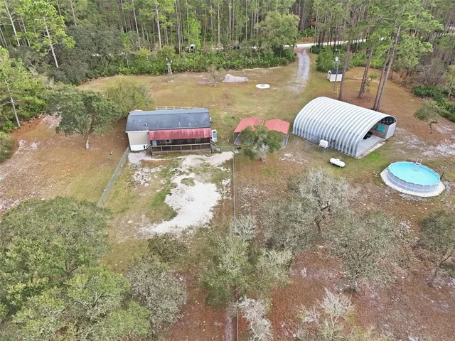 an aerial view of residential house with outdoor space and parking