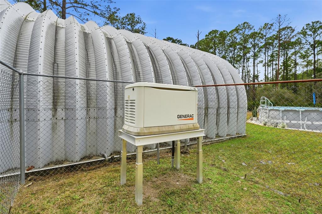 104 Ferncreek Drive Georgetown, FL 32139 - Photo 49 of 52 a backyard of a house with lawn chairs plants and wooden fence