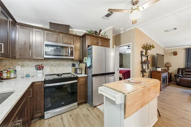 a kitchen with a refrigerator stove and sink