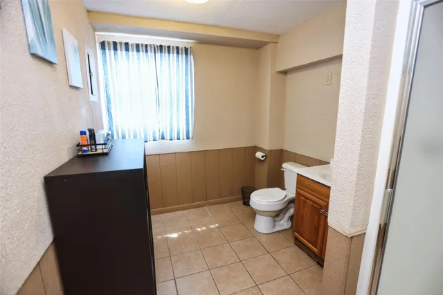 a hallway with sliding door and wooden floor