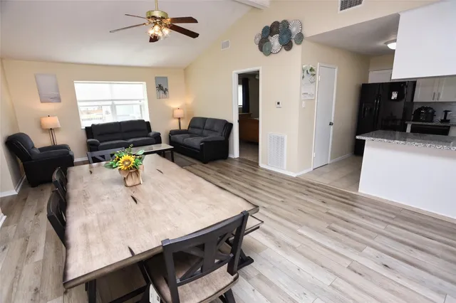 a kitchen with a sink refrigerator and microwave