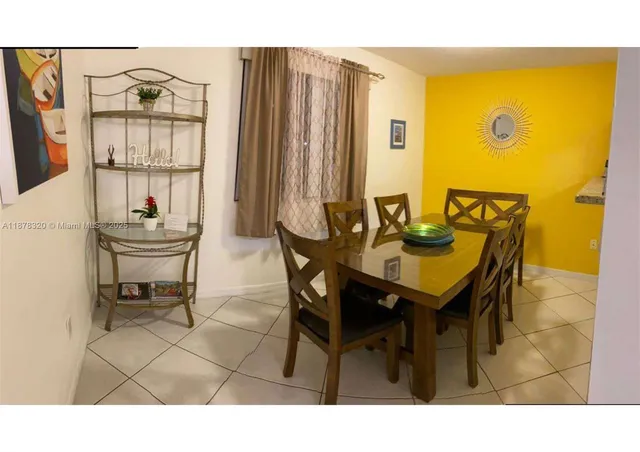 a large bed sitting in a bedroom next to a lamp