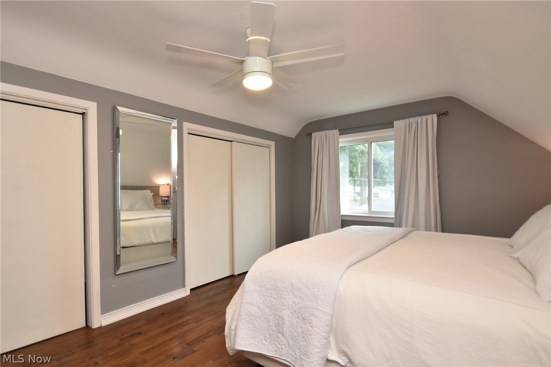 1174 Haverston Road Cleveland, OH 44124 - Photo 17 of 21 Bedroom featuring two closets, lofted ceiling, ceiling fan, and dark wood-type flooring