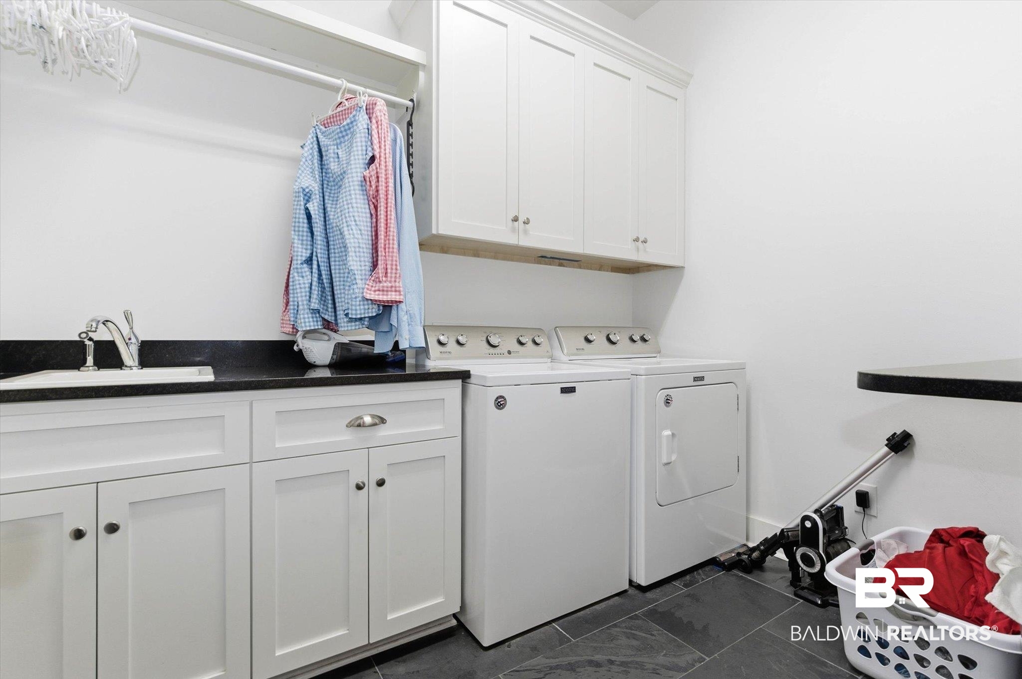 3704 Stein Street Mobile, AL 36608 - Photo 26 of 37 Laundry room with cabinet space, washing machine and dryer, and dark tile patterned flooring