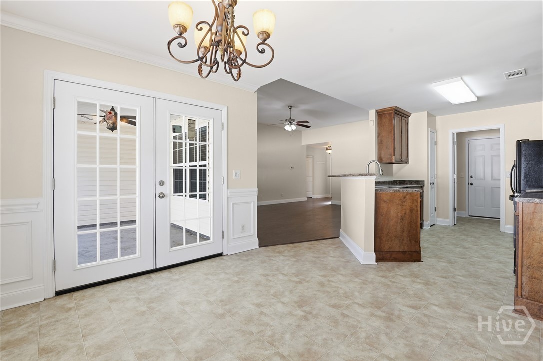 130 Terraza Lane Savannah, GA 31405 - Photo 15 of 31 Standing In Dining Room, Covered Patio with Ceiling Fan Through Doors on the Left, View of the Living Room and Kitchen!