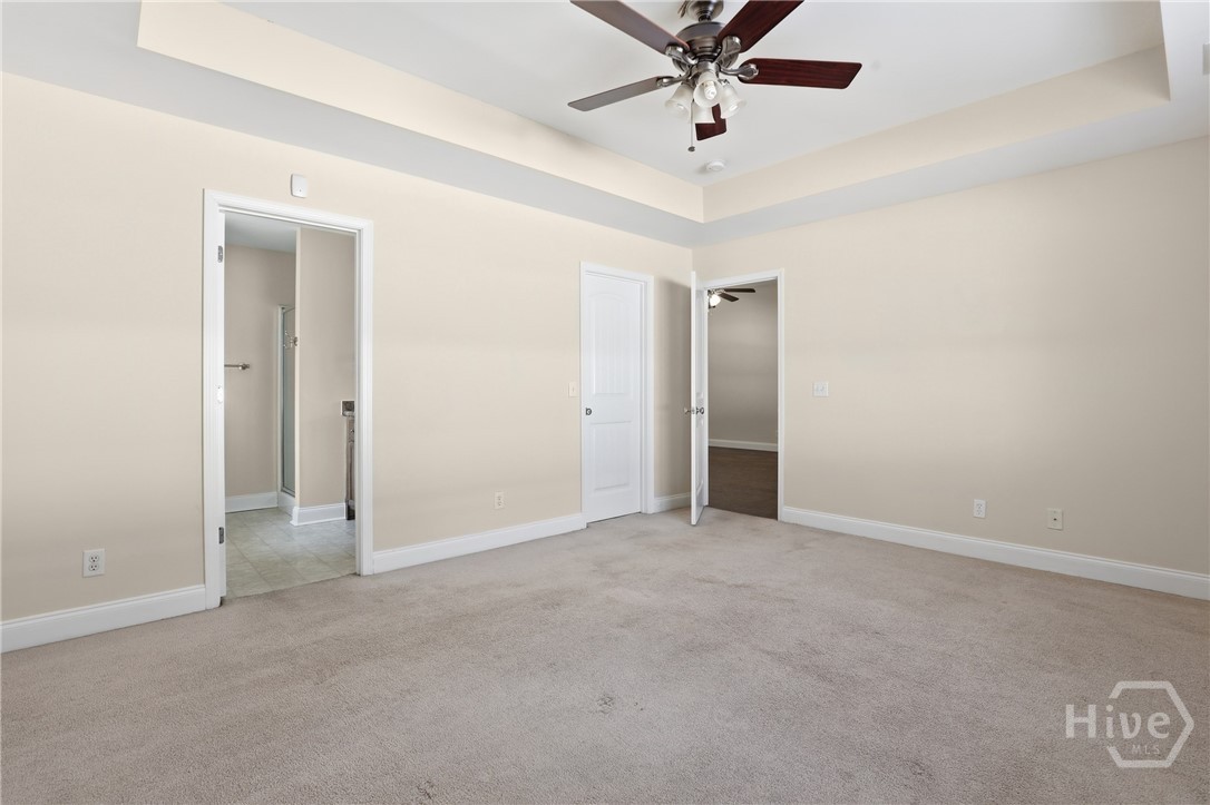 130 Terraza Lane Savannah, GA 31405 - Photo 18 of 31 Primary Suite - Open Door On Left Leads to Primary Bathroom, Closed Door Leads to HUGE Walk in Closet, Far Door Leads to Living Room