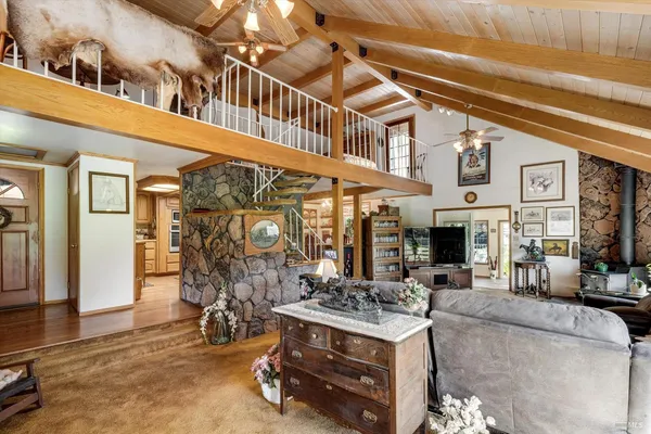 a living room with furniture a window and a flat screen tv