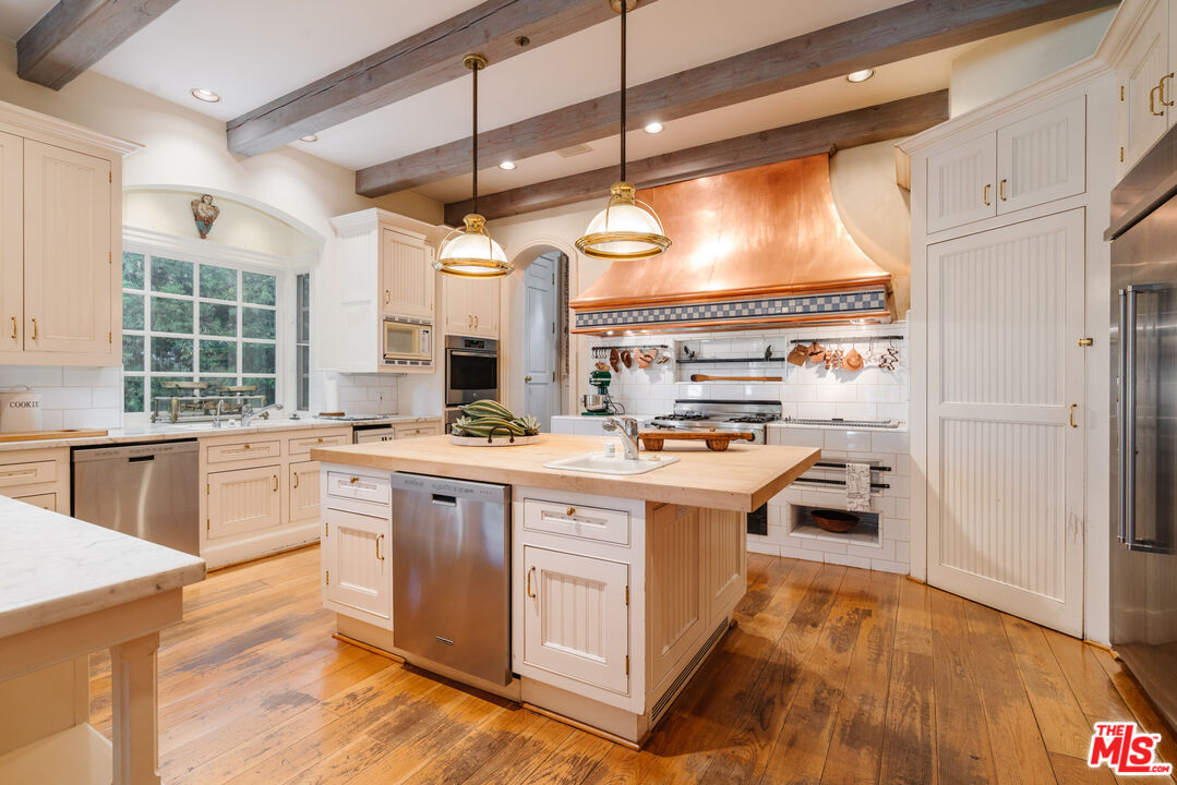 4261 Ledge Avenue Toluca Lake, CA 91602 - Photo 17 of 49 a kitchen with stainless steel appliances granite countertop a stove and a refrigerator