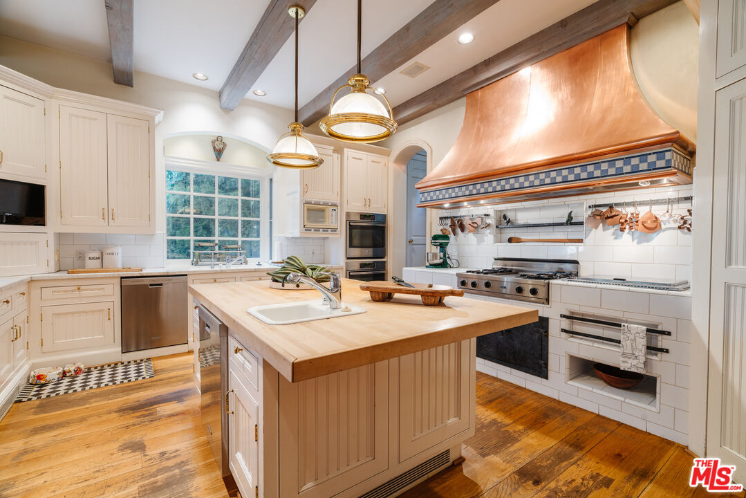 4261 Ledge Avenue Toluca Lake, CA 91602 - Photo 18 of 49 a kitchen with a stove a sink and a refrigerator
