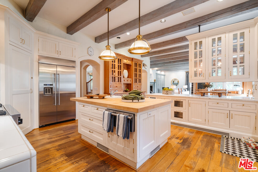 4261 Ledge Avenue Toluca Lake, CA 91602 - Photo 20 of 49 a kitchen with stainless steel appliances granite countertop a stove and a refrigerator