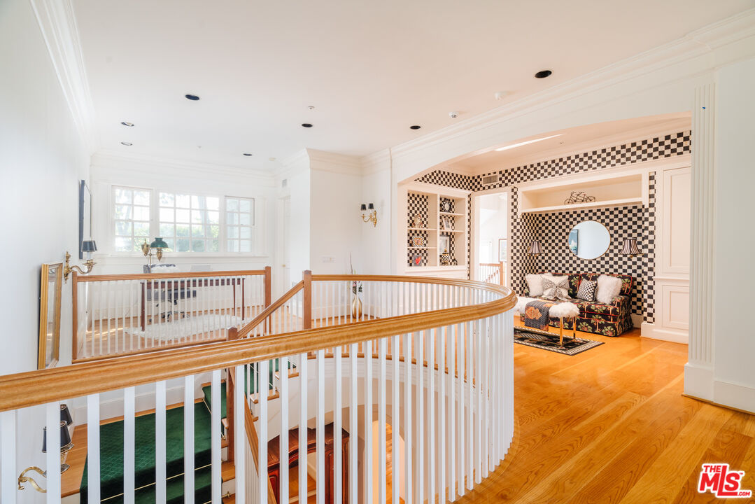 4261 Ledge Avenue Toluca Lake, CA 91602 - Photo 27 of 49 a view of a hallway with wooden floor and windows
