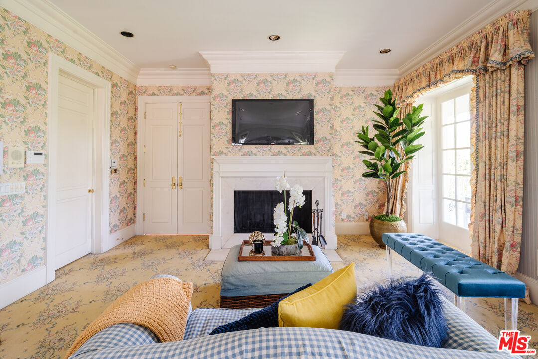 4261 Ledge Avenue Toluca Lake, CA 91602 - Photo 32 of 49 a living room with furniture fireplace and flat screen tv