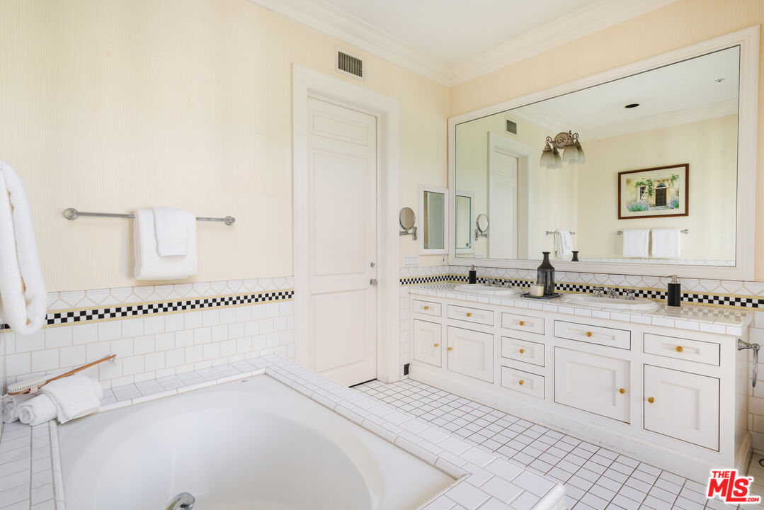 4261 Ledge Avenue Toluca Lake, CA 91602 - Photo 39 of 49 a bathroom with a sink and a mirror
