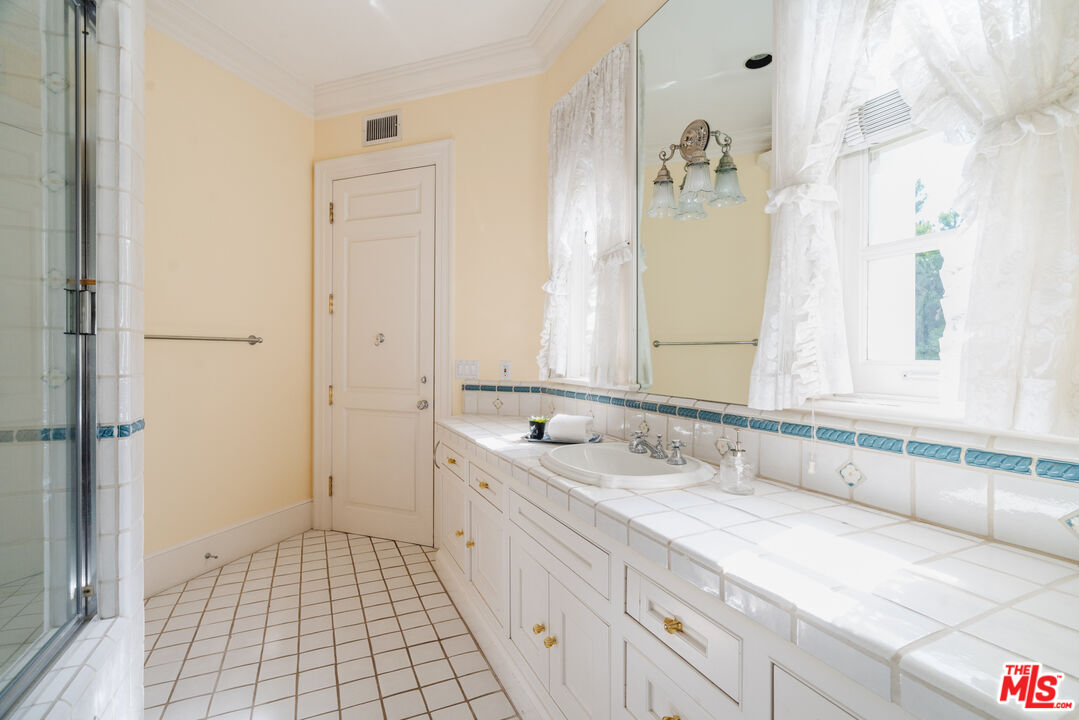 4261 Ledge Avenue Toluca Lake, CA 91602 - Photo 40 of 49 a bathroom with a sink and a mirror