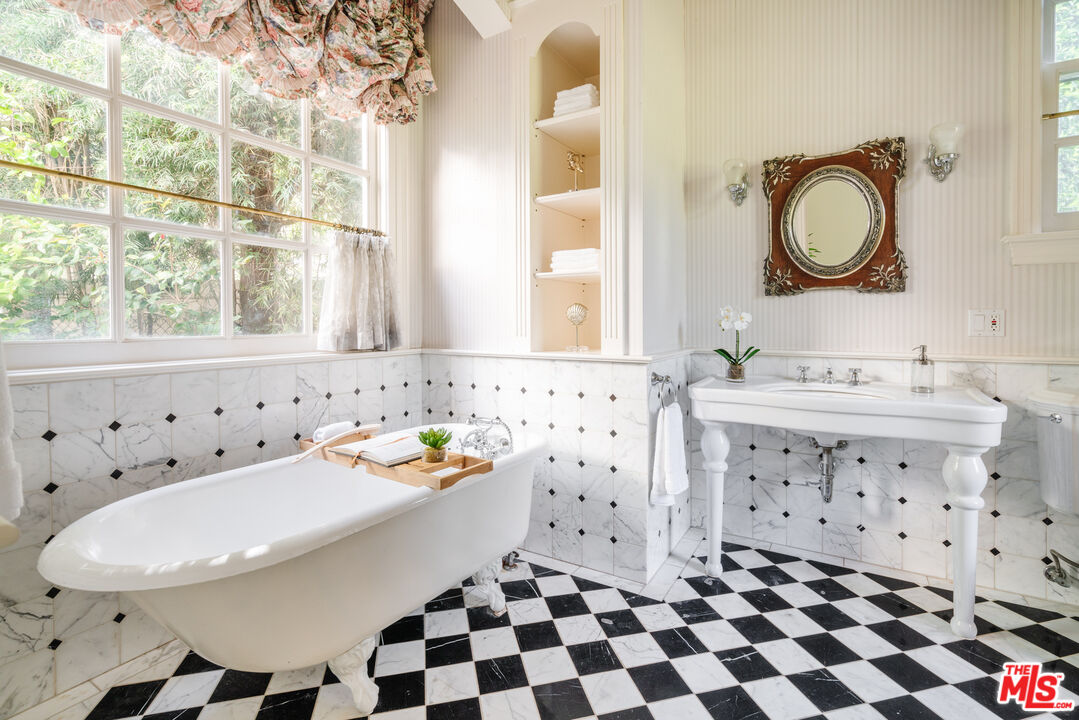 4261 Ledge Avenue Toluca Lake, CA 91602 - Photo 43 of 49 a bathroom with a sink a toilet and a mirror