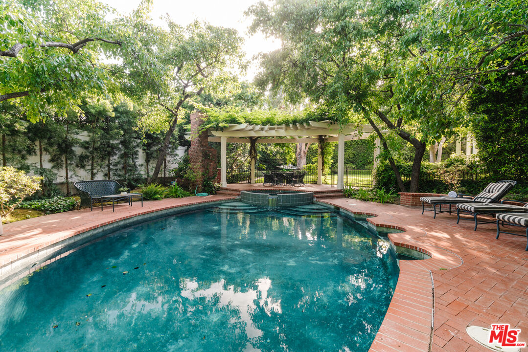 4261 Ledge Avenue Toluca Lake, CA 91602 - Photo 46 of 49 a swimming pool with outdoor seating and yard