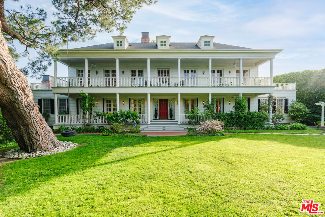 4261 Ledge Avenue Toluca Lake, CA 91602 - Photo 49 of 49 a front view of a house with garden and porch