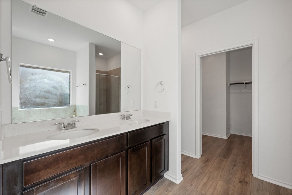 1233 Sweetspire Street Leander, TX 78641 - Photo 16 of 40 Thoughtfully designed primary bath with abundant storage and a spacious walk-in closet connection.