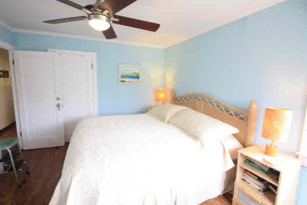4817 Koko Road Hanapepe, HI 96716 - Photo 7 of 21 a bedroom with a bed and a chandelier