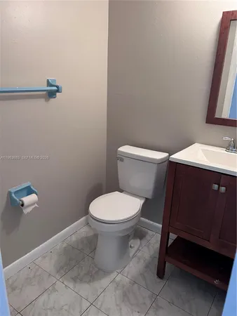 a bathroom with a toilet a sink and a mirror
