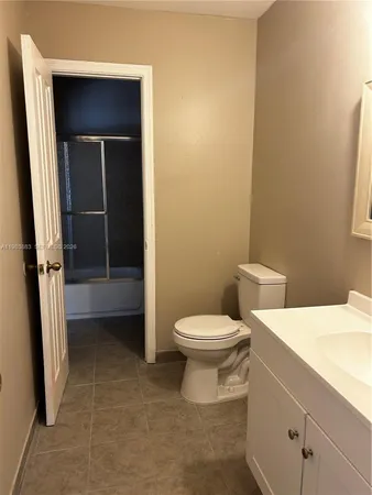 a bathroom with a toilet a sink and shower