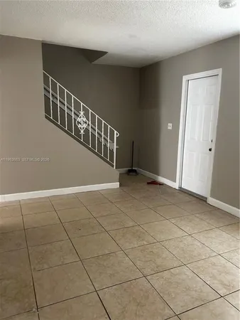 a view of an empty room with stairs