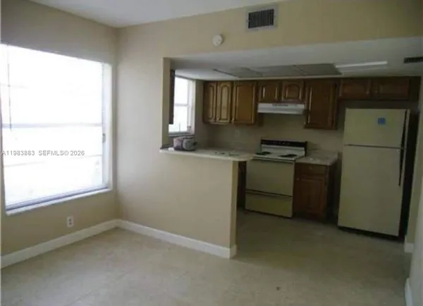 a kitchen with a stove a sink and a refrigerator