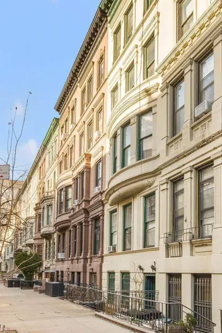 a large building with a street next to a building