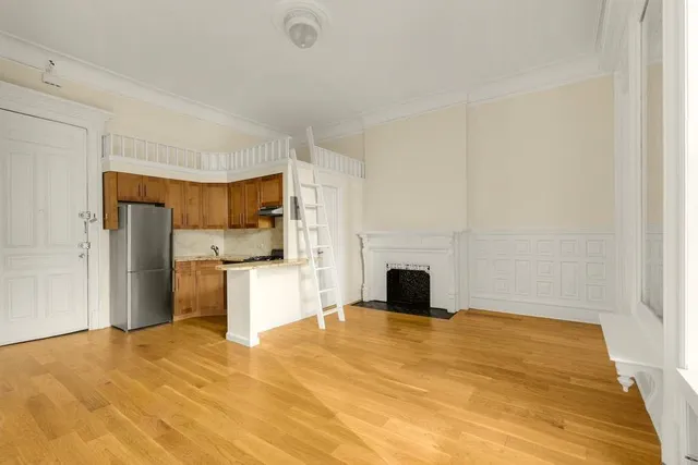 a kitchen with a refrigerator and a stove top oven