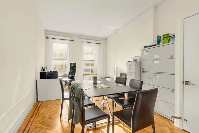 a view of a dining room with furniture and window