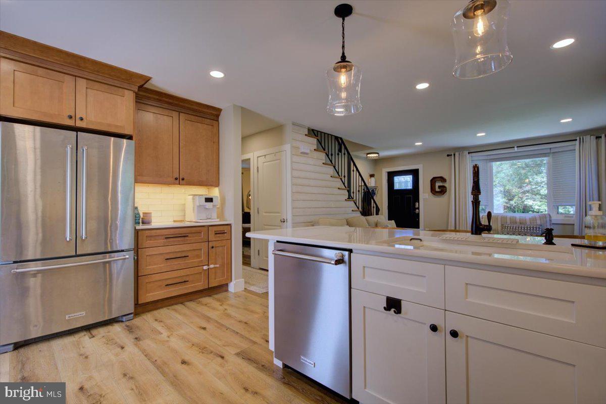 172 Scenic Road Springfield, PA 19064 - Photo 13 of 40 a kitchen with kitchen island granite countertop wooden floors stainless steel appliances and cabinets