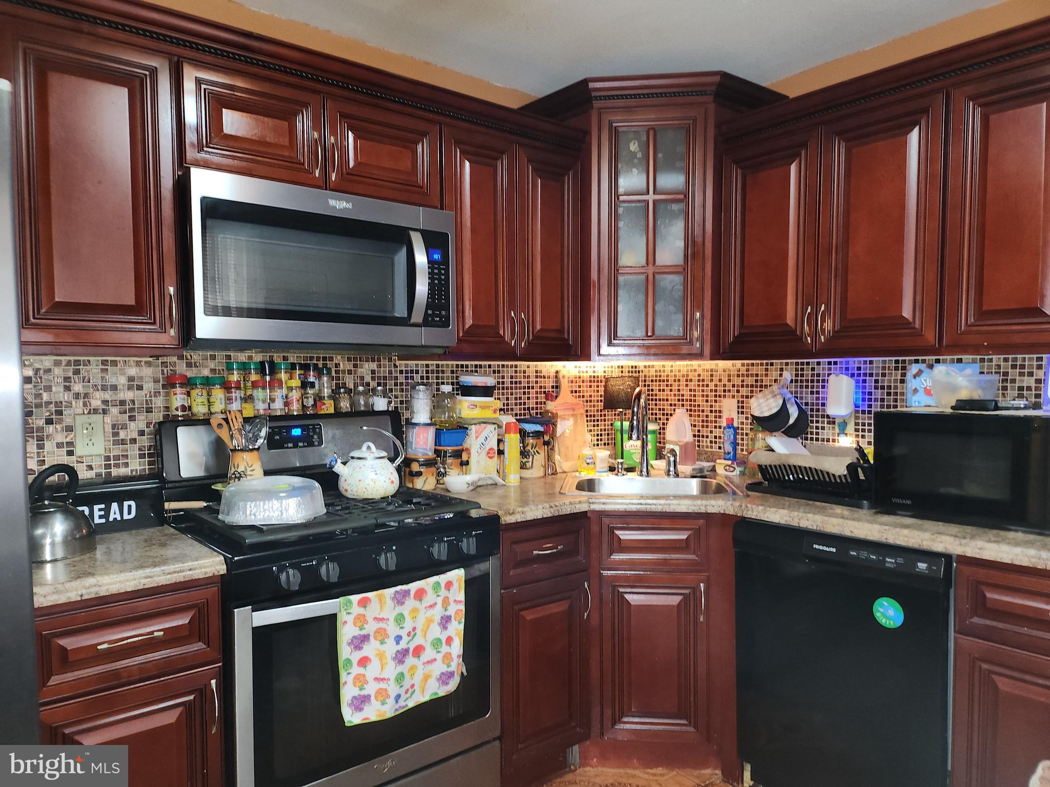 6002 North 19th Street Philadelphia, PA 19141 - Photo 1 of 25 a kitchen with granite countertop a sink stove and microwave