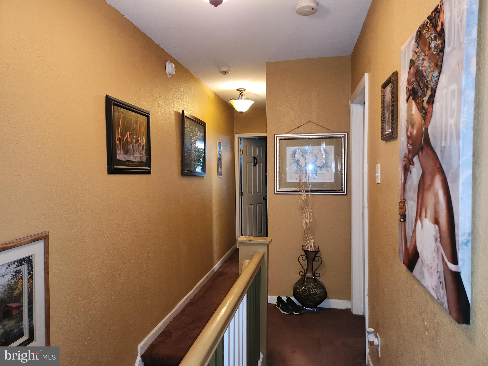 6002 North 19th Street Philadelphia, PA 19141 - Photo 16 of 25 a view of a hallway with paintings on the wall