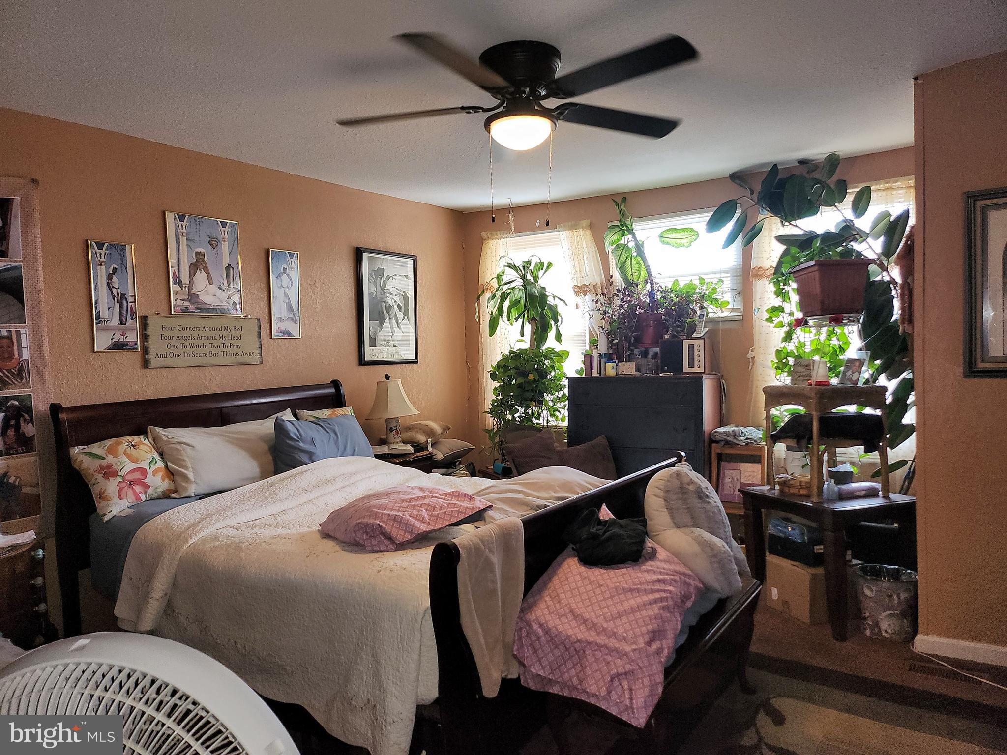 6002 North 19th Street Philadelphia, PA 19141 - Photo 18 of 25 a bed room with a bed and a chandelier