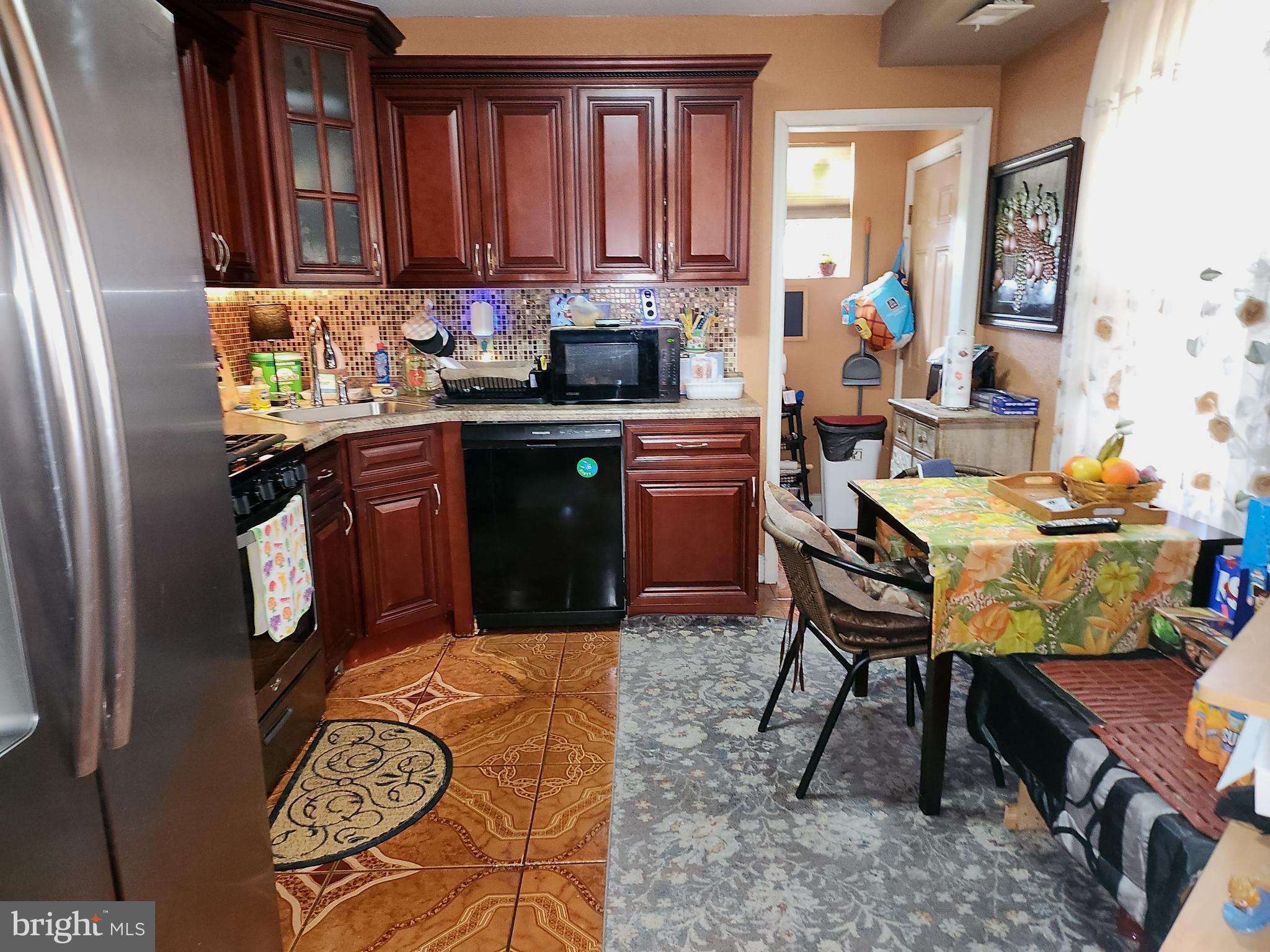 6002 North 19th Street Philadelphia, PA 19141 - Photo 3 of 25 a kitchen with a sink cabinets and window