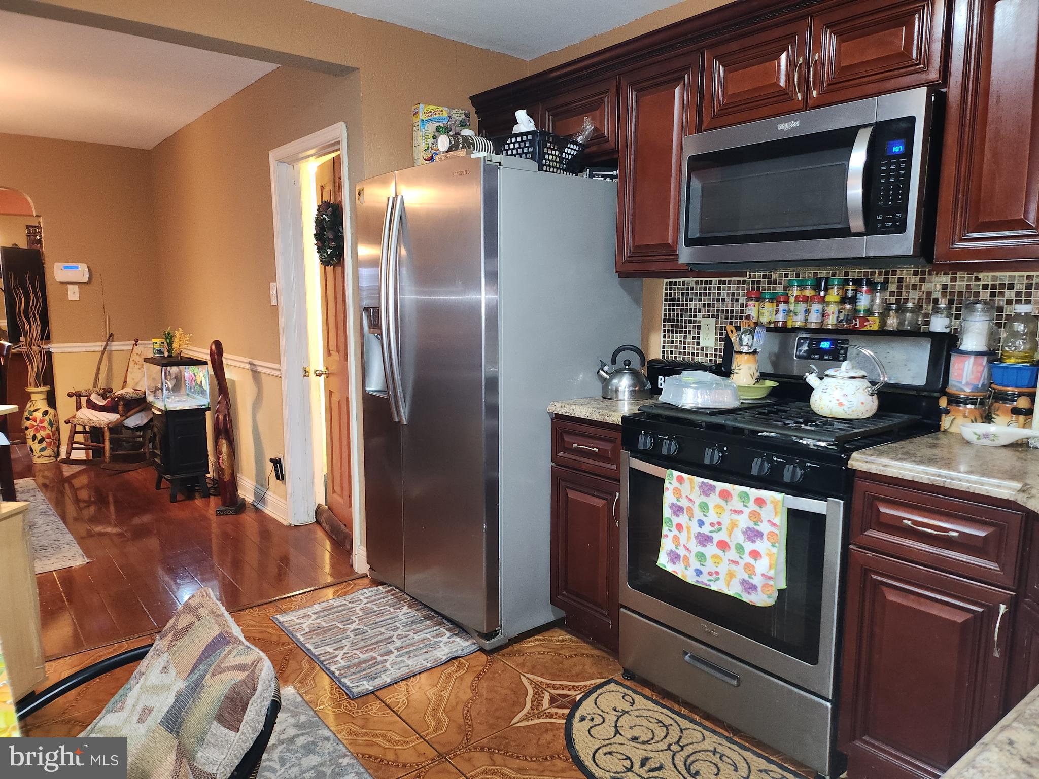 6002 North 19th Street Philadelphia, PA 19141 - Photo 4 of 25 a kitchen with stainless steel appliances granite countertop a stove a microwave and a sink