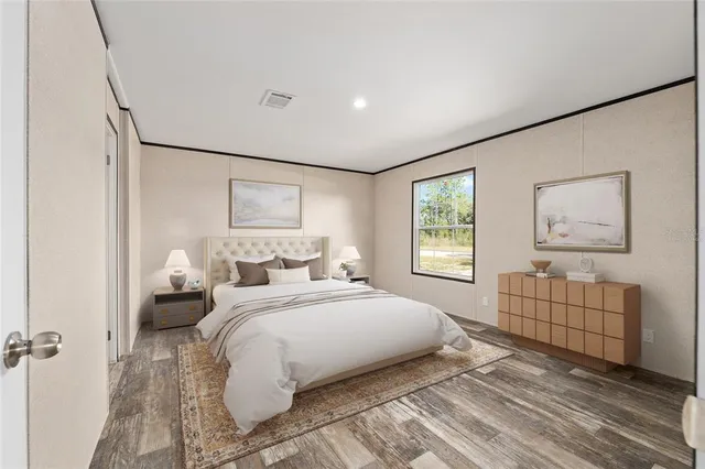 a bedroom with a bed and a painting on the wall