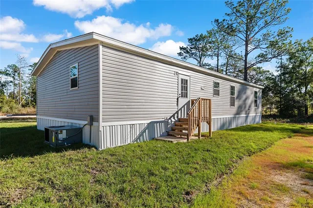 a view of backyard with a garden and deck