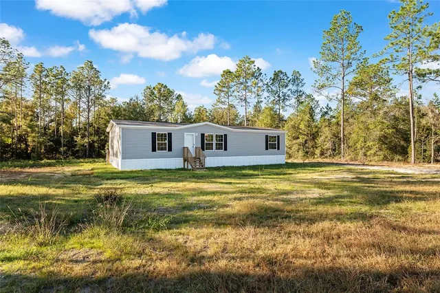 a swimming pool with outdoor seating and yard