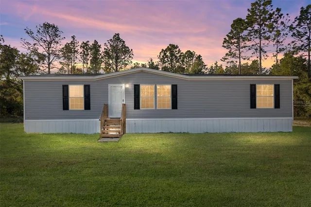 a view of a house with a yard and garage
