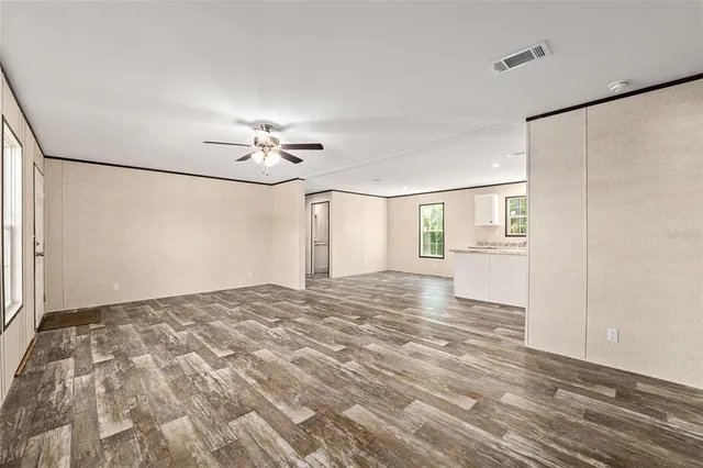 a view of a livingroom with a ceiling fan and window