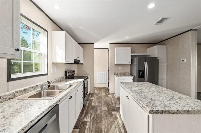a kitchen with a sink stove and refrigerator