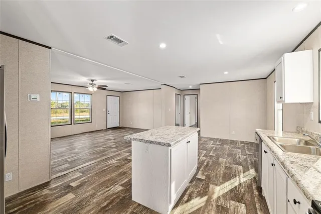 a spacious bathroom with a granite countertop sink a mirror and a shower