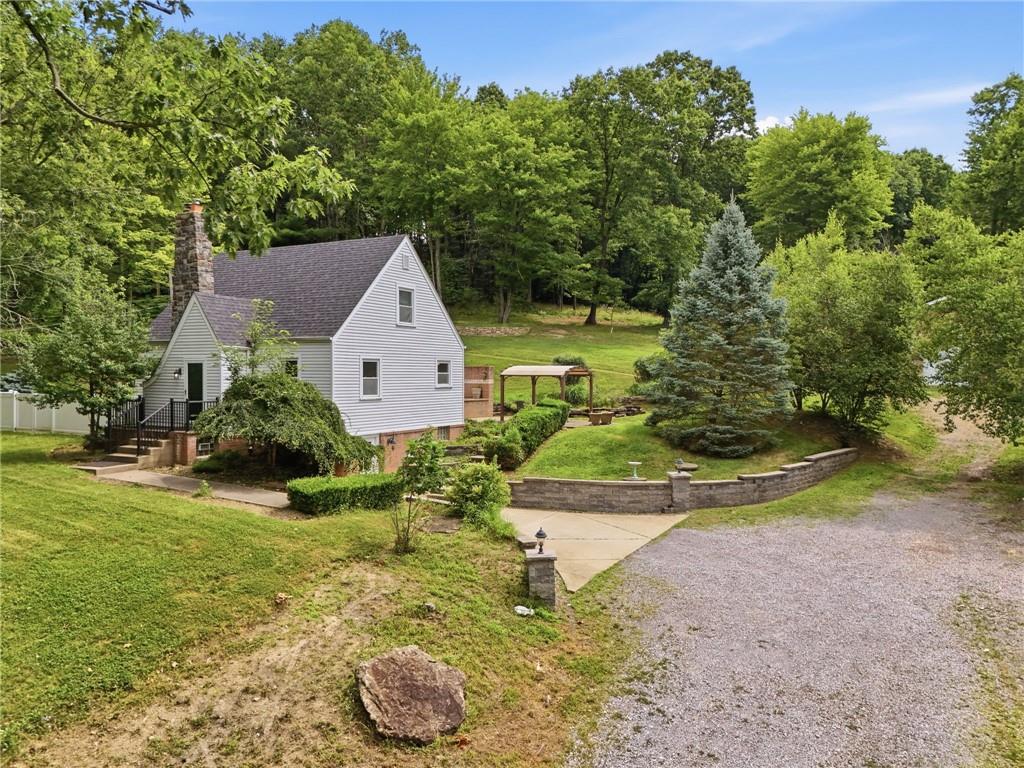809 Franklin Road Mars, PA 16046 - Photo 3 of 44 Front exterior showcasing classic rooflines and private wooded lot